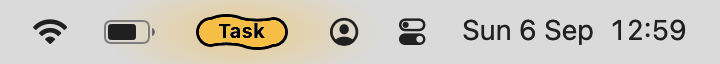 The macOS menu bar with Task's tag carrying the word Task in place of a Desktop number